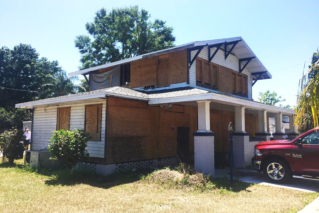1007 W. Baker before renovation: boarded windows, unfinished siding